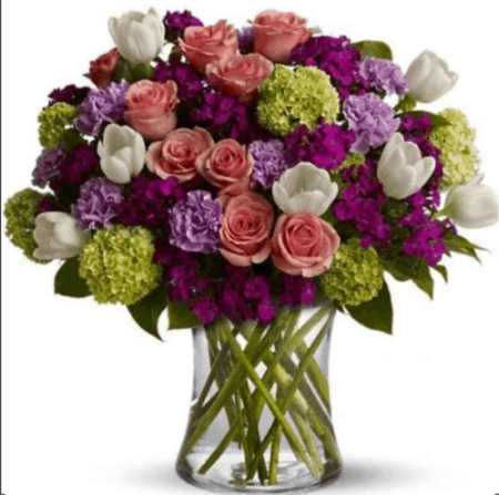 Roses, tulips, carnations and more - in the prettiest hues of pink, purple, white and green - create a beautiful all-around bouquet. A mix of fresh flowers such as roses, tulips, carnations and viburnum – in shades of green, pink, white and lavender – are arranged in a glass vase. Approximately 14" (W) x 19" (H)