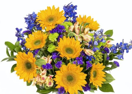 This bouquet features an assortment of fresh sunflowers, delphinium & more inside a clear glass gathering vase.