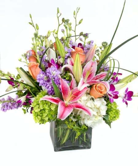 Purple dendrobium orchids are set in contrast with roses and green hydrangea. Its bursting with beauty and love. This arrangement will warm the heart of its lucky recipient