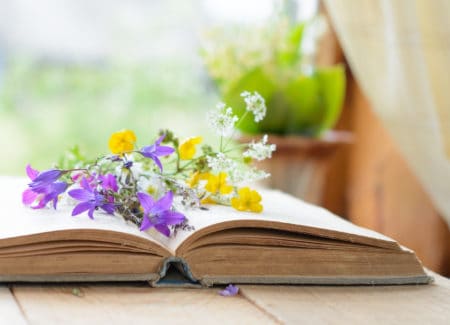 Vintage book with bouquet of meadow flowers