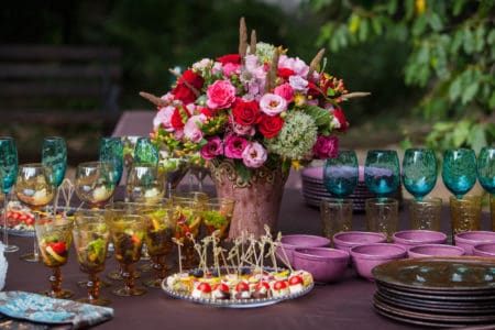 Large pink flower arrangement on food table